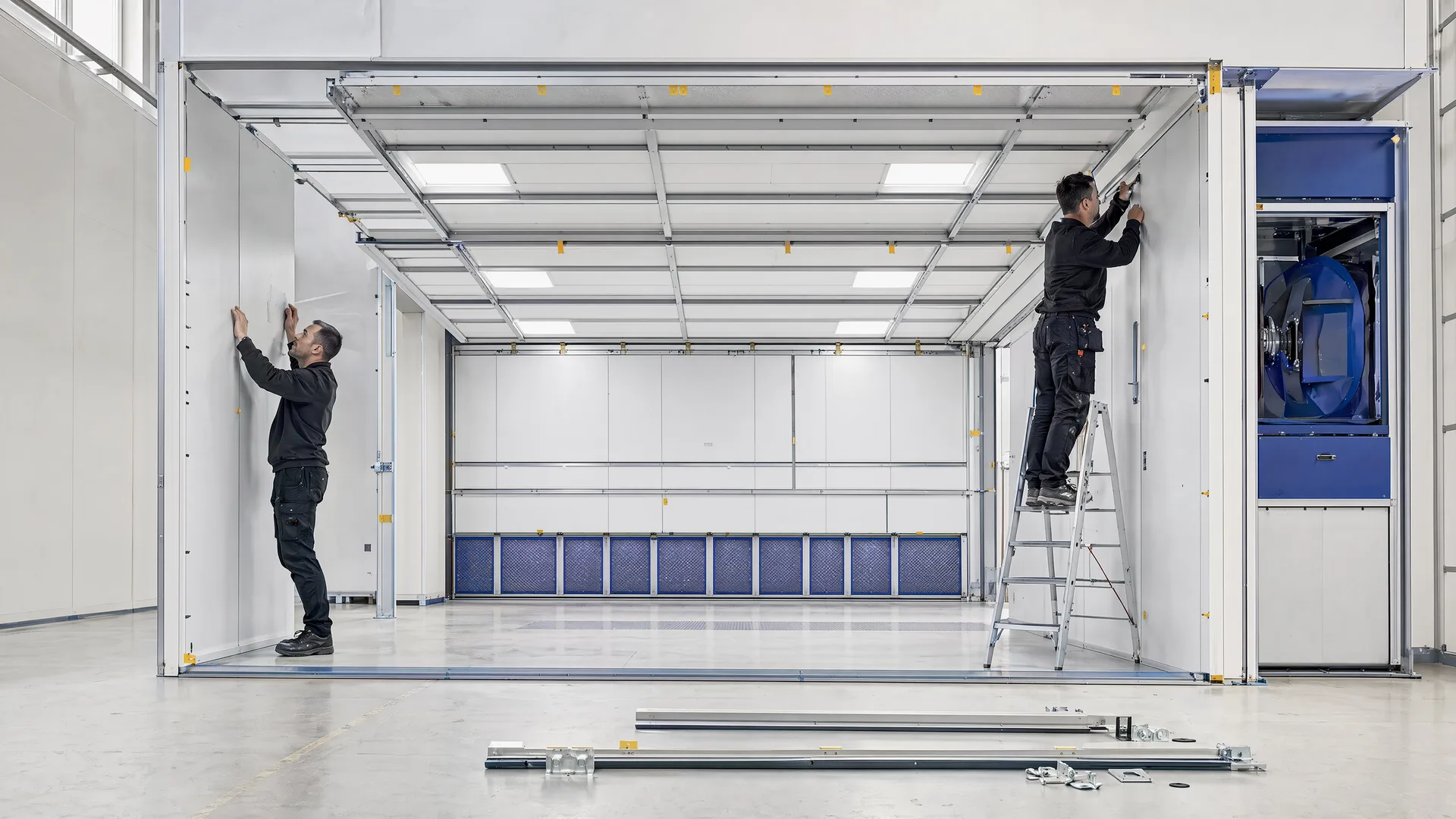 Representative local team assembling modular spray-booth panels